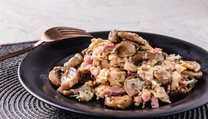 Scrambled eggs with mushrooms and ham. Spanish dish